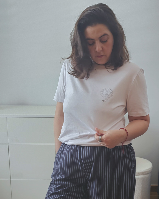 White organic cotton t-shirt with a small shell print on the chest, Aurora Soulwear.