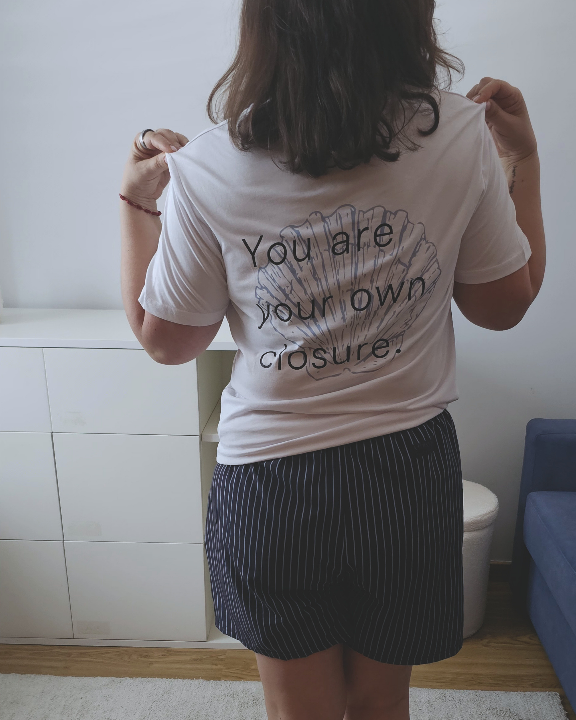 White organic cotton t-shirt with a small shell print on the chest, Aurora Soulwear.