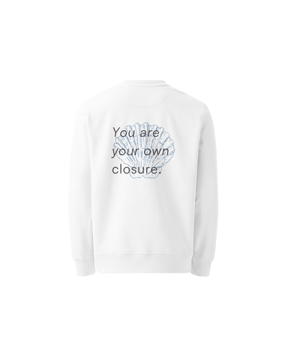 White organic sweater with a small shell print on the chest, Aurora Soulwear.
