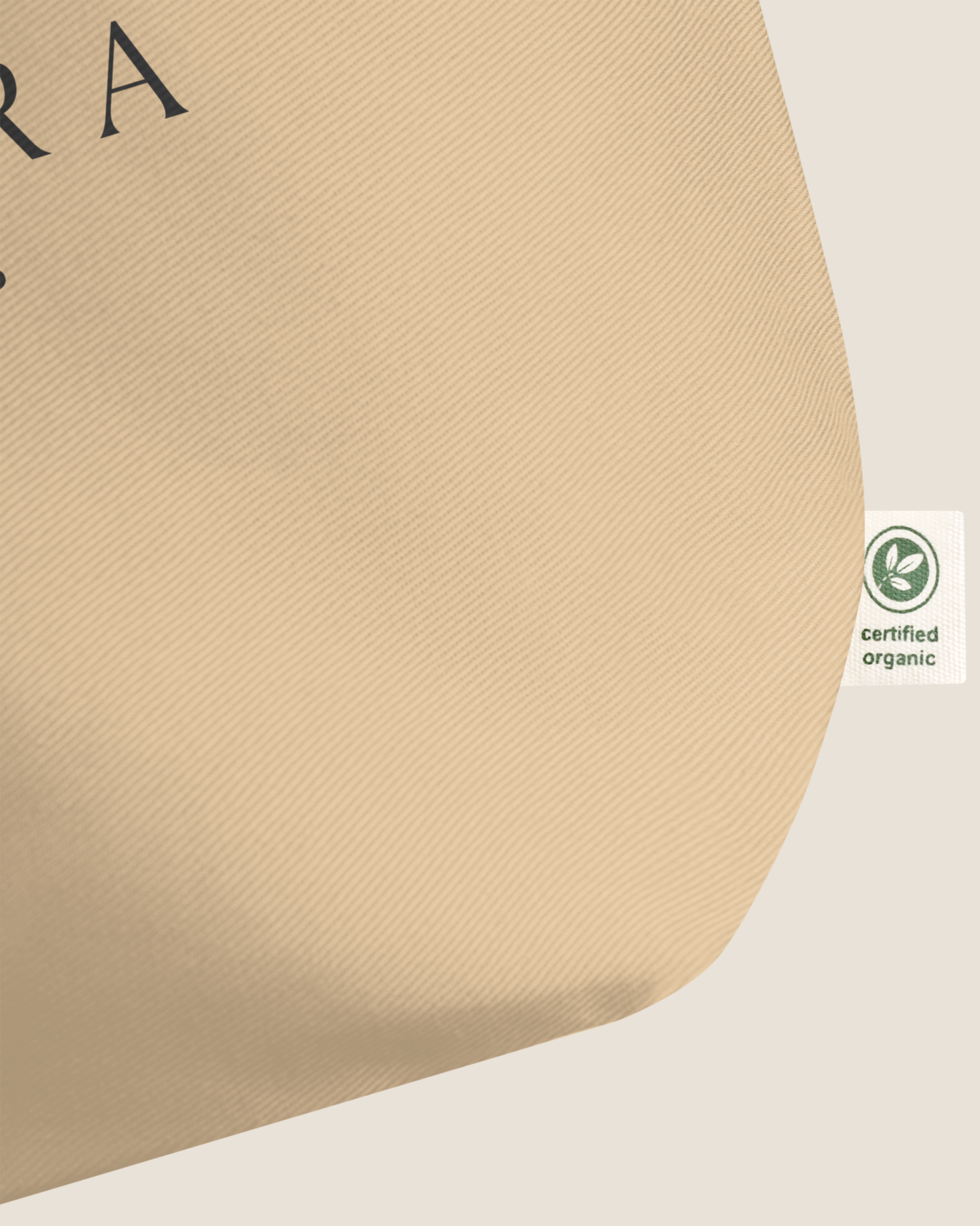 A close-up of beige organic cotton fabric with a green "certified organic" label.