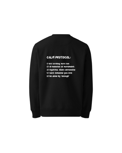 Protocol Organic Sweater in black with Calm Protocol back print