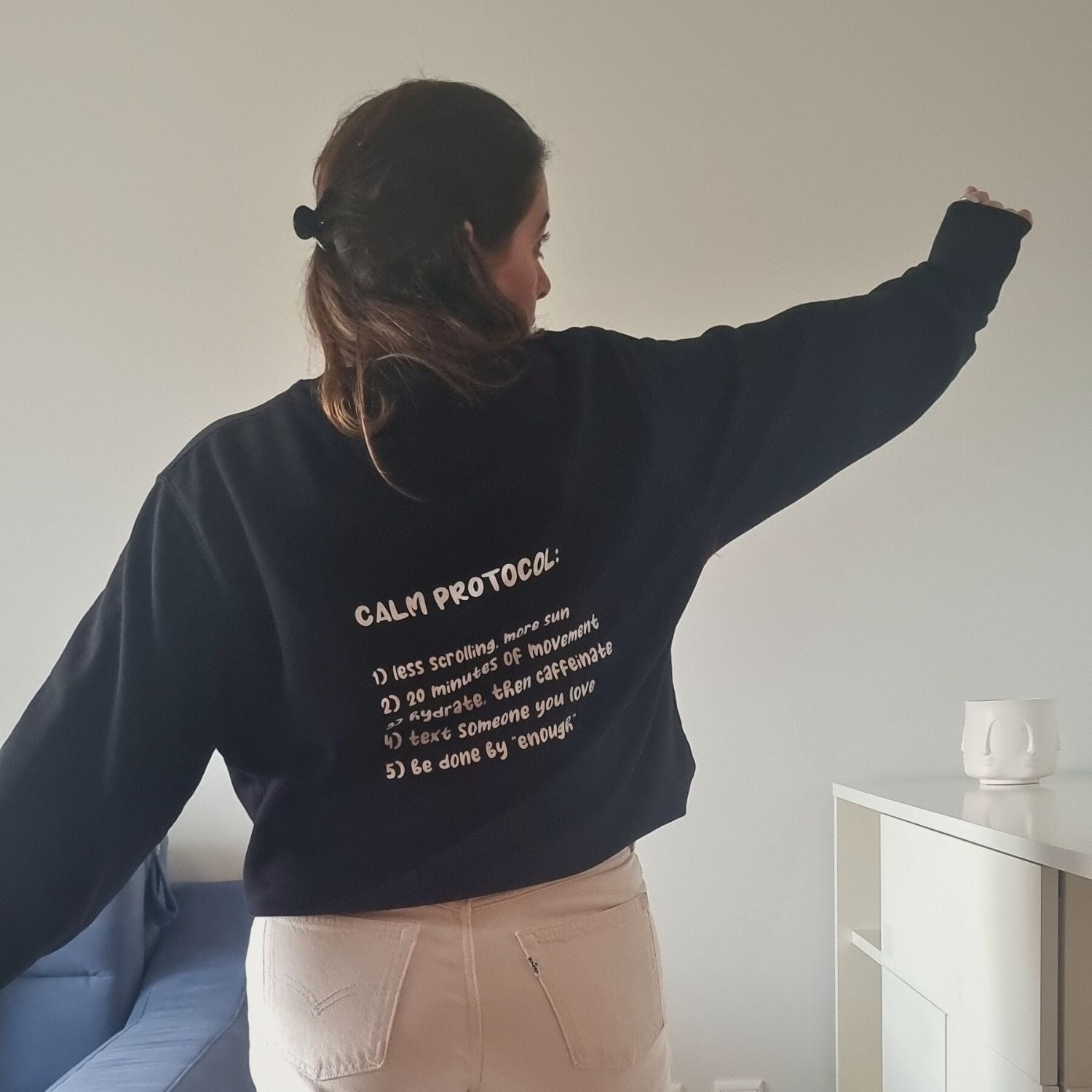 Protocol Organic Sweater in black with Calm Protocol back print